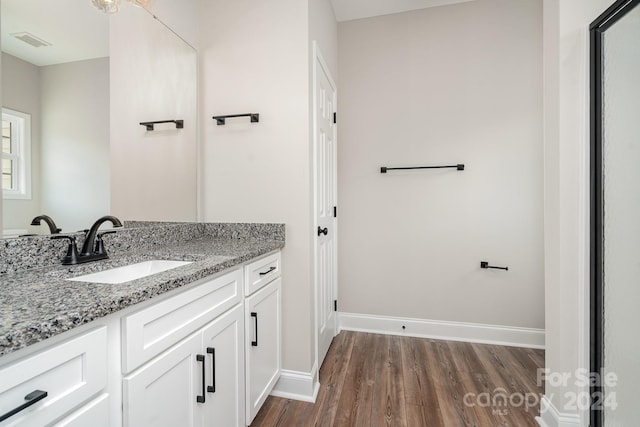 bathroom with vanity and hardwood / wood-style flooring