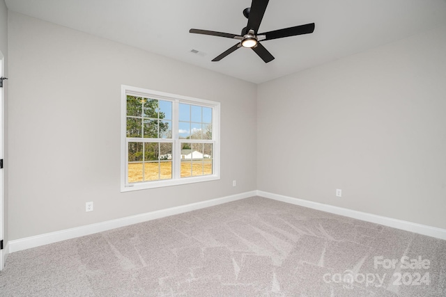 empty room featuring carpet floors and ceiling fan