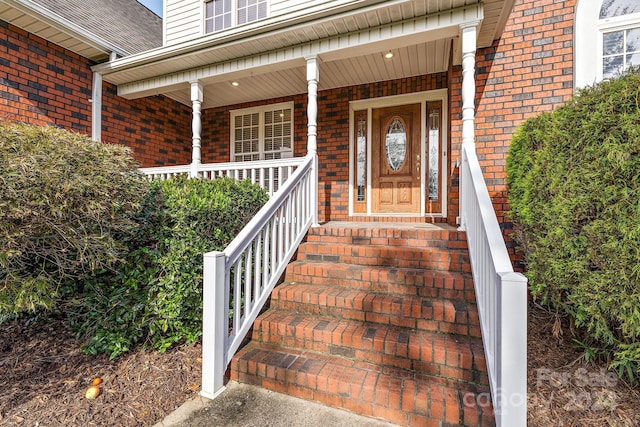 view of exterior entry with covered porch