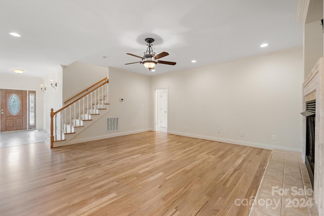 unfurnished living room featuring ceiling fan, crown molding, and light hardwood / wood-style floors