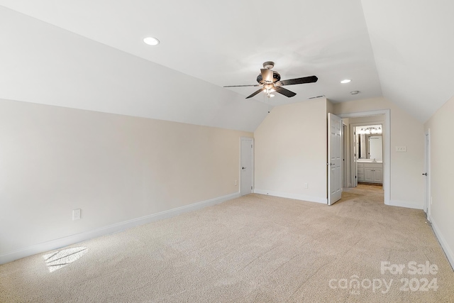 additional living space with light carpet, lofted ceiling, and ceiling fan