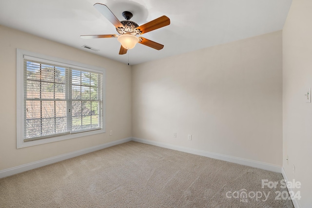 carpeted empty room with ceiling fan