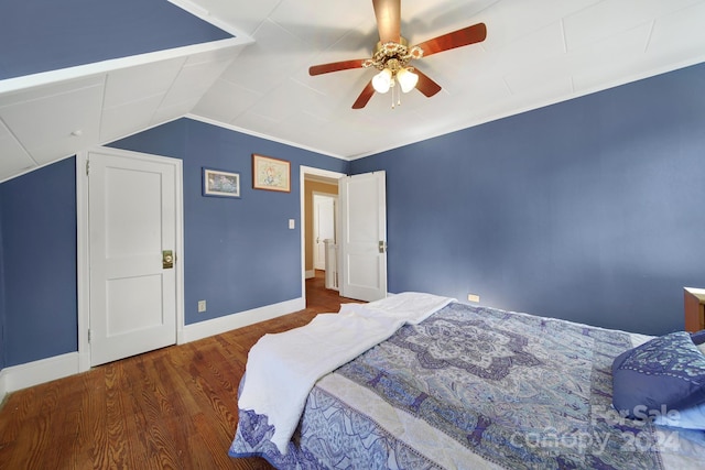 bedroom featuring ceiling fan, dark hardwood / wood-style flooring, and vaulted ceiling