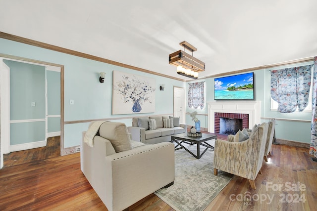 living room featuring hardwood / wood-style floors and a brick fireplace