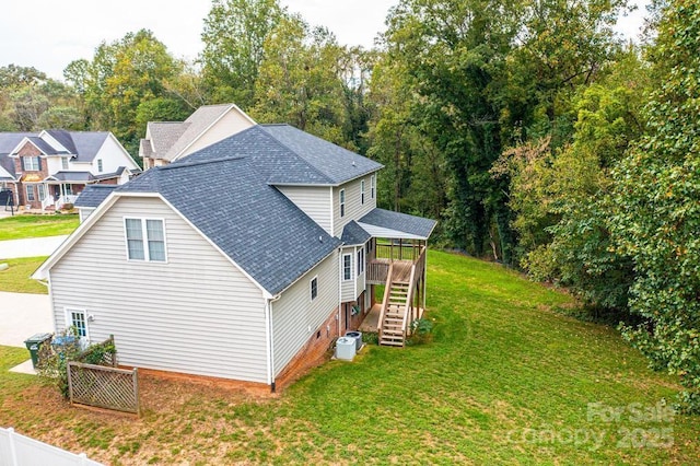 view of side of home featuring a yard and a deck