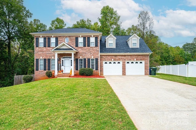 colonial house featuring a garage and a front yard