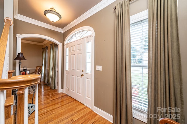 entrance foyer featuring light hardwood / wood-style flooring and crown molding