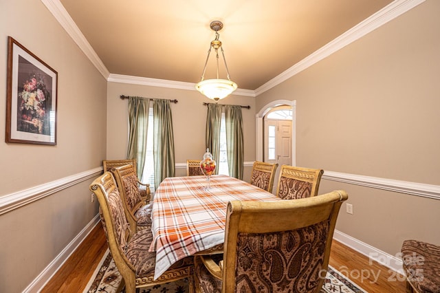 dining room with crown molding and dark hardwood / wood-style floors