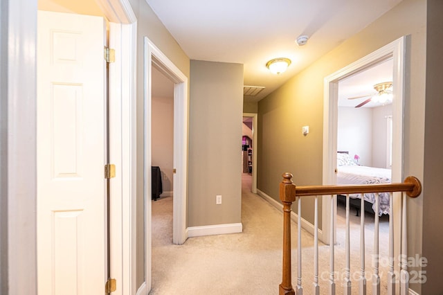 hall featuring light colored carpet