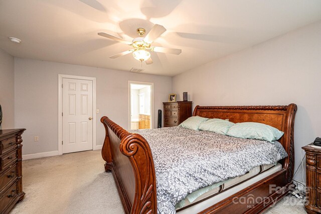 carpeted bedroom with ceiling fan and connected bathroom