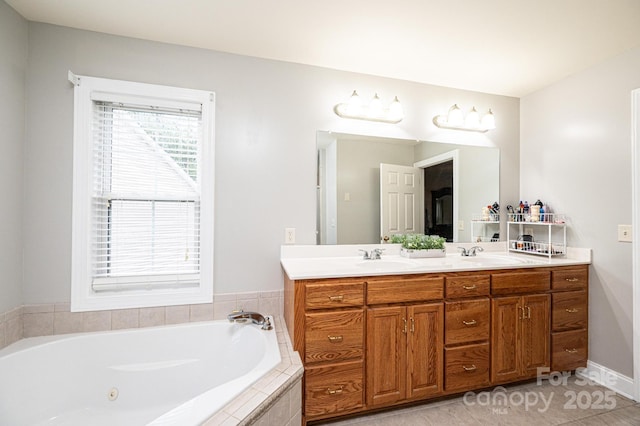 bathroom featuring tile patterned flooring, vanity, and a relaxing tiled tub