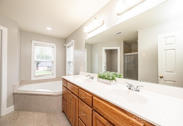 bathroom with tile patterned floors, vanity, and separate shower and tub