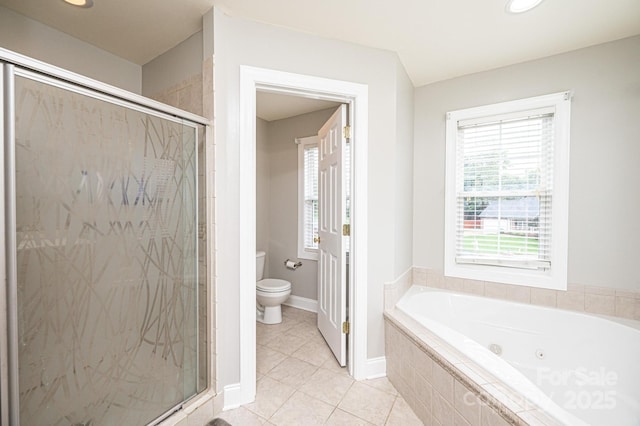 bathroom with tile patterned floors, toilet, and shower with separate bathtub