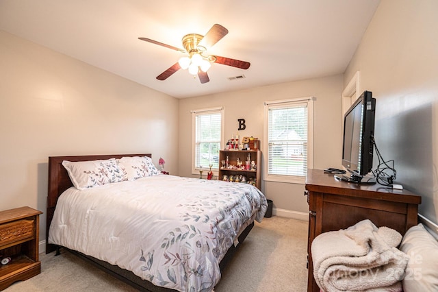 bedroom with ceiling fan and light colored carpet