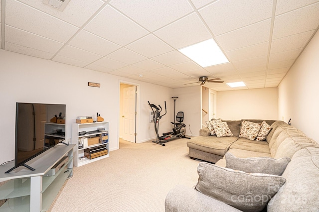 living room with ceiling fan, a drop ceiling, and carpet floors