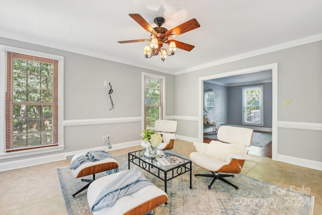 living area featuring ornamental molding, light tile patterned floors, and ceiling fan