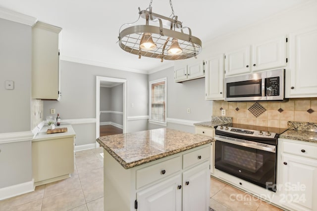 kitchen featuring a center island, appliances with stainless steel finishes, and white cabinetry