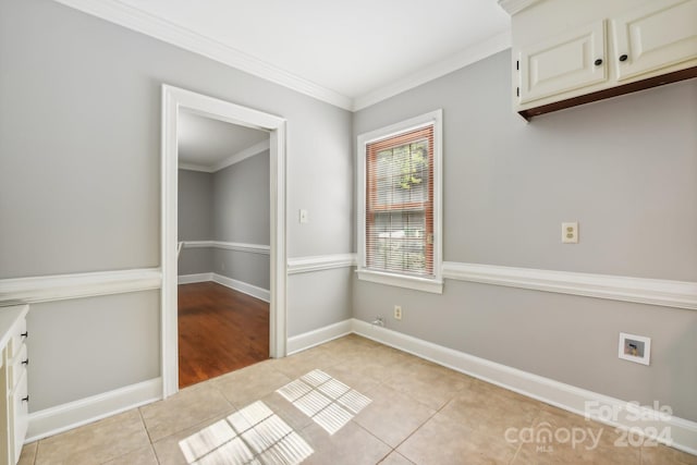 unfurnished dining area featuring ornamental molding and light tile patterned floors