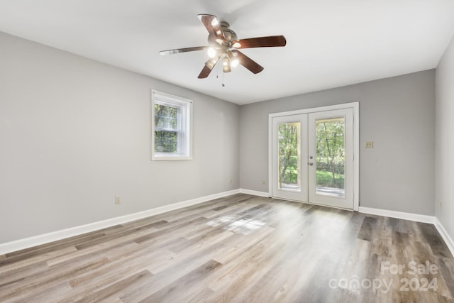 spare room with french doors, light hardwood / wood-style floors, and ceiling fan