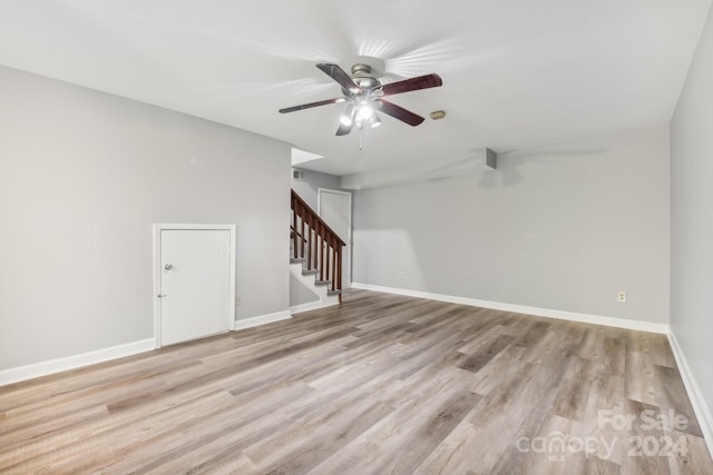 spare room with ceiling fan and light wood-type flooring