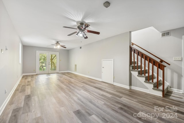 unfurnished living room featuring light hardwood / wood-style floors, french doors, and ceiling fan