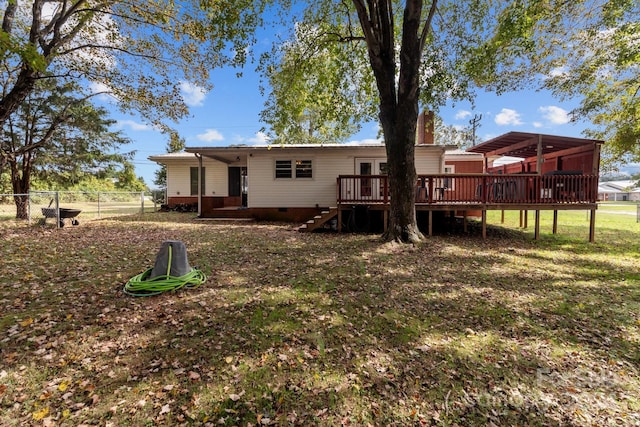 back of house with a wooden deck and a yard