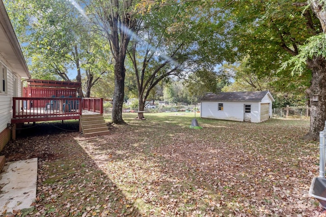 view of yard featuring a wooden deck and an outdoor structure