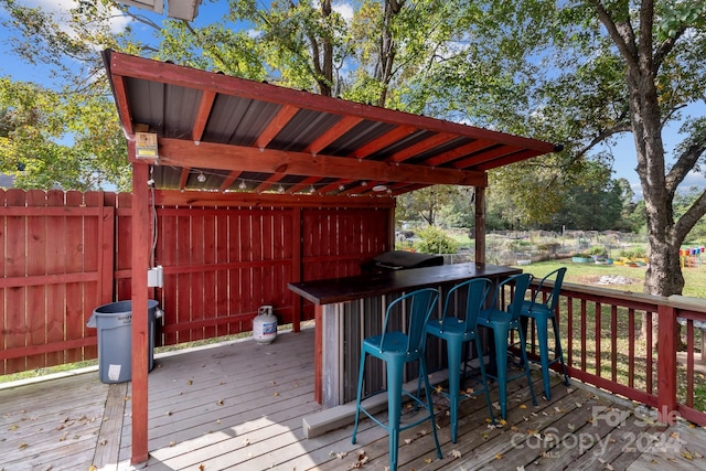 wooden deck featuring an outdoor bar and area for grilling