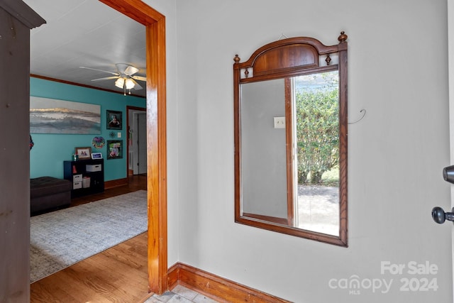 entryway with light hardwood / wood-style flooring, ceiling fan, and crown molding