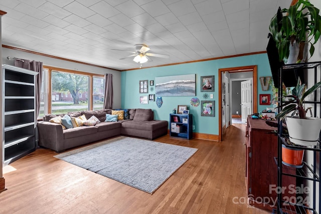 living room featuring ornamental molding, ceiling fan, and hardwood / wood-style flooring