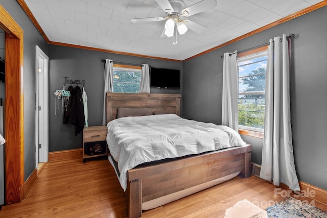 bedroom with ceiling fan, crown molding, and light hardwood / wood-style floors