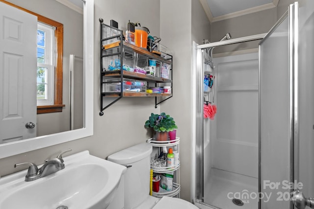 bathroom featuring walk in shower, ornamental molding, sink, and toilet