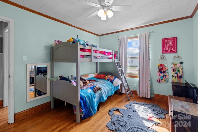 bedroom featuring crown molding, ceiling fan, and hardwood / wood-style flooring