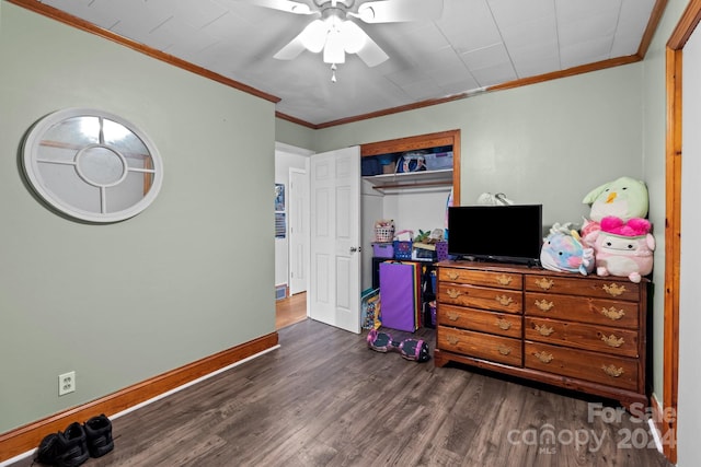 bedroom with ornamental molding, ceiling fan, and dark wood-type flooring