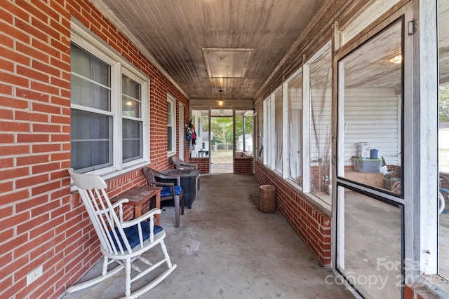 sunroom featuring wooden ceiling