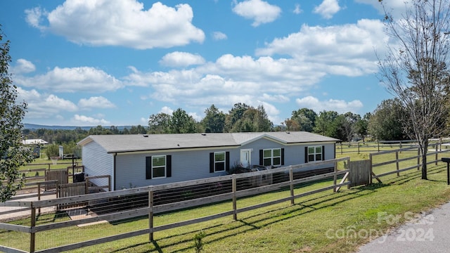 view of front of property with a rural view and a front lawn