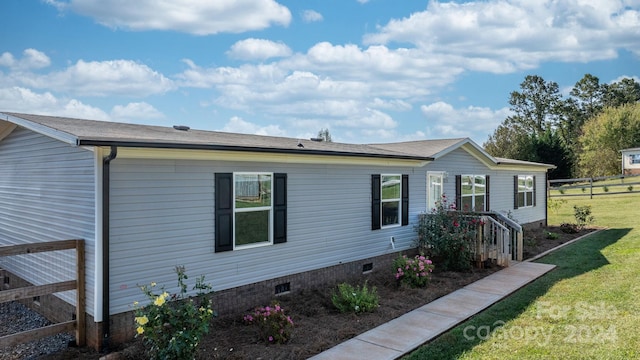 view of property exterior featuring a lawn