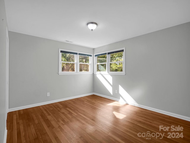 empty room with hardwood / wood-style floors