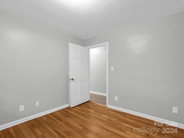 spare room featuring wood-type flooring