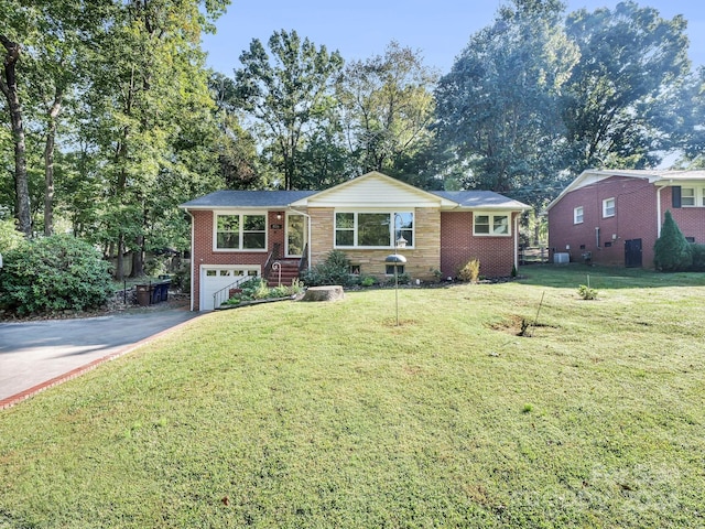 view of front of home with a garage and a front lawn