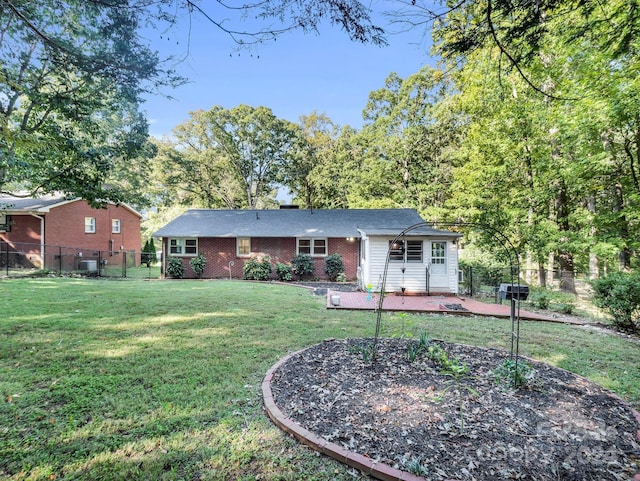 view of front facade with a front lawn and a patio area