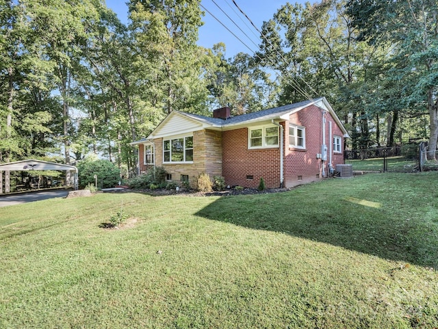 view of side of home featuring a lawn, central AC, and a carport