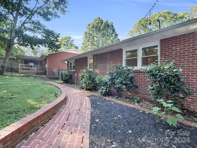 view of property exterior with a yard