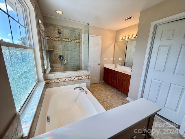 bathroom with shower with separate bathtub and vanity