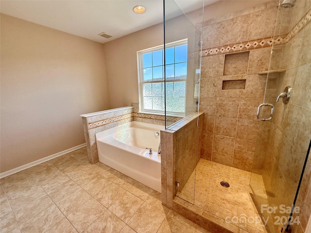 bathroom with independent shower and bath and tile patterned flooring