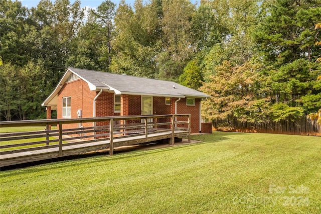 exterior space with a front yard and a wooden deck