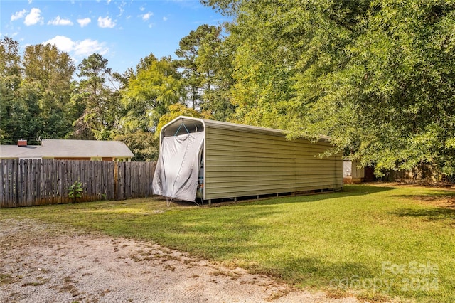 view of outbuilding featuring a lawn