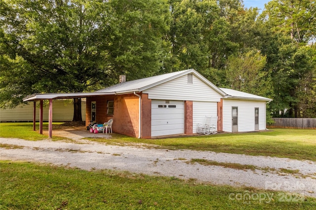 garage with a lawn and a carport