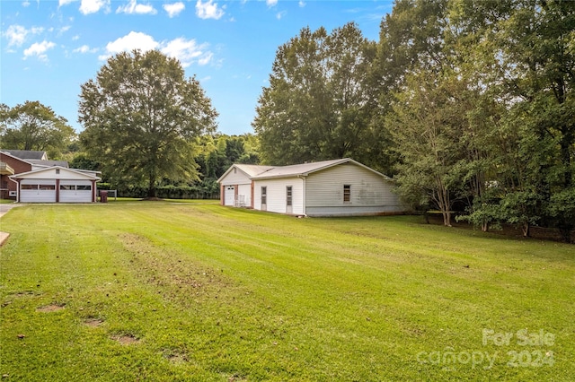 view of yard with a garage and an outdoor structure