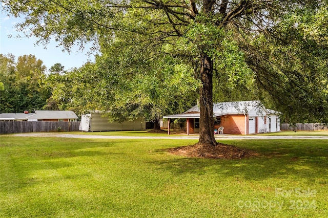 view of front facade with a storage shed and a front lawn